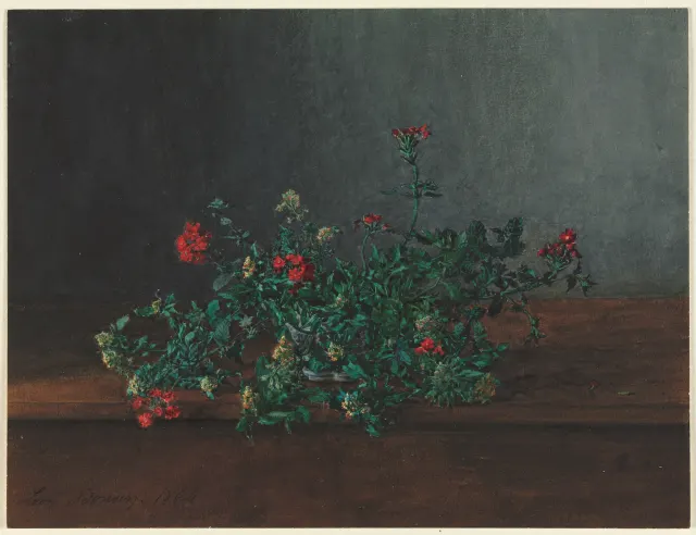 Watercolor still life of red and yellow-green wildflowers with dense leaves lying on a wooden ledge before a dark wall.